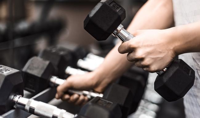 a person grabbing dumbells