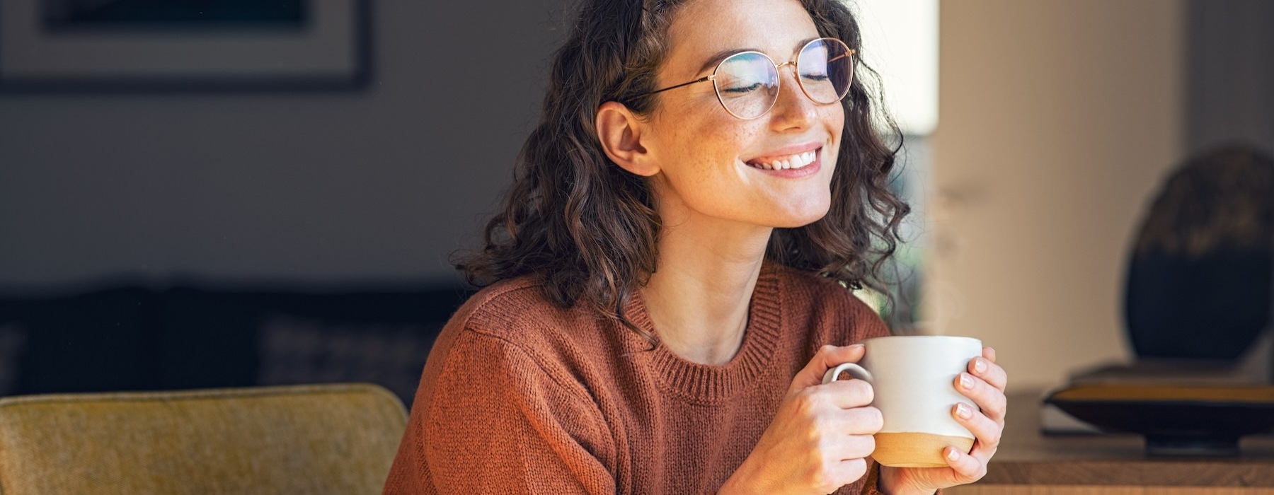 a woman holding a cup