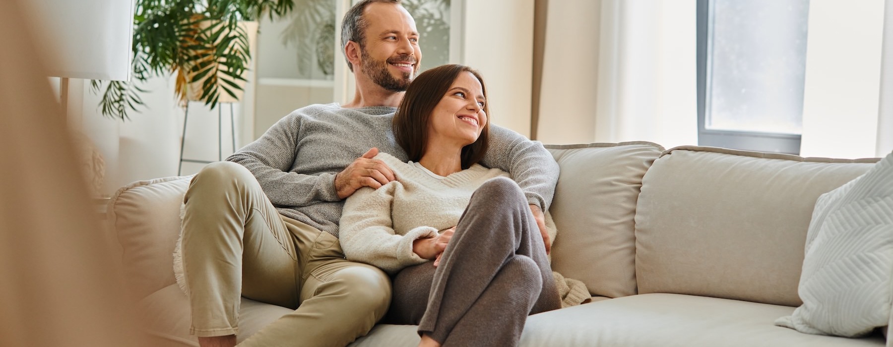 a man and woman sitting on a couch